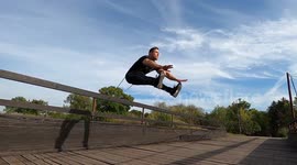Fitness model doing exercise with resistance band outdoor on the bridge.