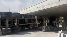 Bungling lorry driver forgets container height and crashes into low bridge
