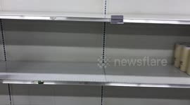 Shelves almost empty of Paper Towels