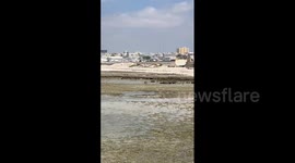 Plume of smoke following reports of explosion at entrance of Aden Adde Airport in Somalia