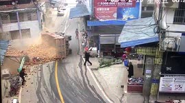Two dead after overloaded truck carrying bricks flips over while turning corner in southern China