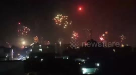 A series of families set off fireworks in a town in Vietnam, making the whole sky blazing like a war