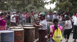 Myanmar villagers make roadblock with oil drums and benches to stop military and police from moving