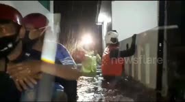 Heroic firemen carry out women trapped in rising floods in Indonesia
