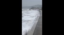 Watch as 150 year old seawall, with endangered railway line, gets pounded by waves in Dawlish, Devon as bystanders look on