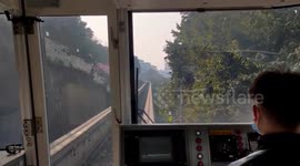 Drone crashes into light-rail train passing through scenic hillside in southern China