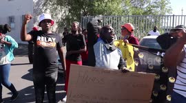 Supporters and opponents of South African police commander accused of sexual harassment face off outside court
