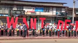 Anti-coup demonstrators display 'we want democracy' banners in Myanmar protest