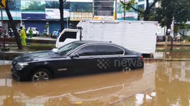 Monsoon floods hit Indonesian capital. BMW stuck in the flood in Jakarta