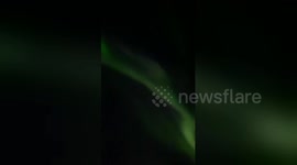 Northern lights shine above the skies of Reykjavik