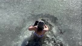 This human resources rep. starts her days by swimming under ICE in a frigid lake