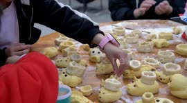 Family make Chinese zodiac animals out of dough to celebrate Lantern Festival