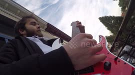 Belgian man performs epic metal concert on balcony for school kids