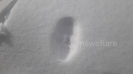 Woman smashes face in snow and leaves her face print