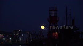 Snow Moon Rises Next To East London Lighthouse