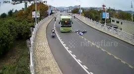 Teenagers on motorcycle escape serious injuries after skidding into oncoming bus in China