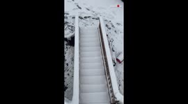 Man Uses Power Washer for Removing Snow from Staircase