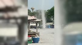 Landspout tornado whips through dusty car park in Thailand