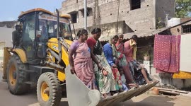 A pack of seven people travelling in the bucket of a earth mover caught attention of all in Southern India