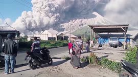 Villagers watch as Mount Sinabung erupts in Indonesia
