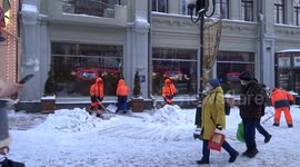 Snow shovelers cleaning snow on Old Arbat on the last day of winter - Moscow