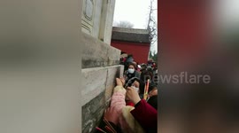 Tourists in China queue to touch hole they say represents 'female genitalia' in hope to increase fertility