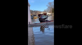 Tractor pushes car through floodwaters in Kentucky