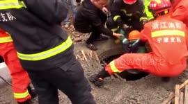 Chinese firefighters rescue boy who fell through road into deep well