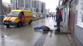 Engineer is fixing a sewer grate with his head in it