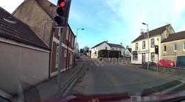 Two cyclists blatantly riding through red lights and narrowly avoiding a collision.