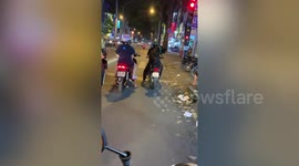 Dog balances on back of a motorcycle riding pillion