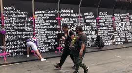 Protestors marked the names of all female victims on the National Palace of Mexico wall in honor of International Women's Day