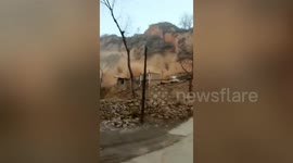 Wave of debris triggered by landslide buries houses in northern China