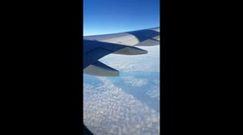 A beautiful figure floating in the sky and clouds from the plane.