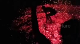 Stunning moment Indian villagers hurl red hot embers to make 'rain of fire'