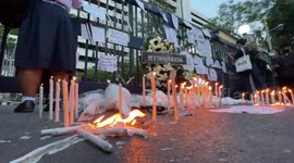 Thai anti-establishment protesters light candles in mock funeral after leaders denied bail