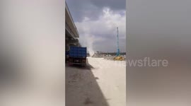 Dust devil tornado forms on building site in Philippines