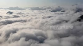 Spectacular drone footage showcases sea of clouds flowing over mountain tops in central China