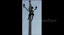 Old man rescued from powerline after climbing up during family marriage dispute