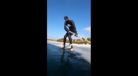 Canadian free diver creates incredible illusion by playing hockey on underside of ice