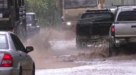 Vehicles drive through flooded streets as Hawaii hit by devastating floods