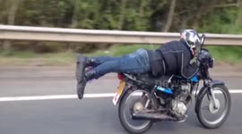 Man performs superman motorbike stunt on motorway