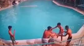 Drowning boy rescued after being spun round by friends and pushed into swimming pool