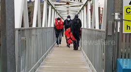 Illegal migrants walking ramp after being picked up by Border Force