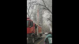 Fire Engines roar by as Shijiazhuang 26-story building burns