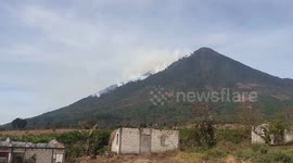 Hundreds of firefighters battle to stop forest fire advancing up volcano in Guatemala