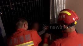 Firefighters rescue alleged drunk man hanging from 28th-floor window in southern China
