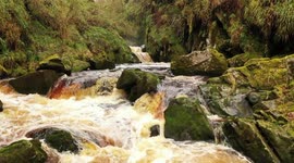 Drone Flying Low Over River and Waterfall