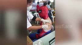 Filipino comic fan receives COVID-19 jab while dressed as Spider-Man
