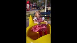 Whiplash airplane ride at the playground. Toddler vigorously riding toy.